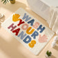 Cream bath mat with message of wash your hands