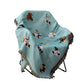 Mint green throw blanket with different dogs on chair