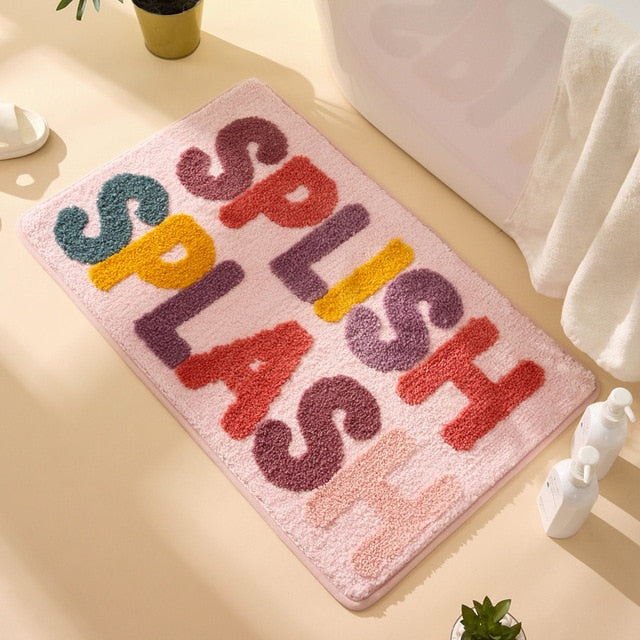 Cream bath mat with message of splish splash