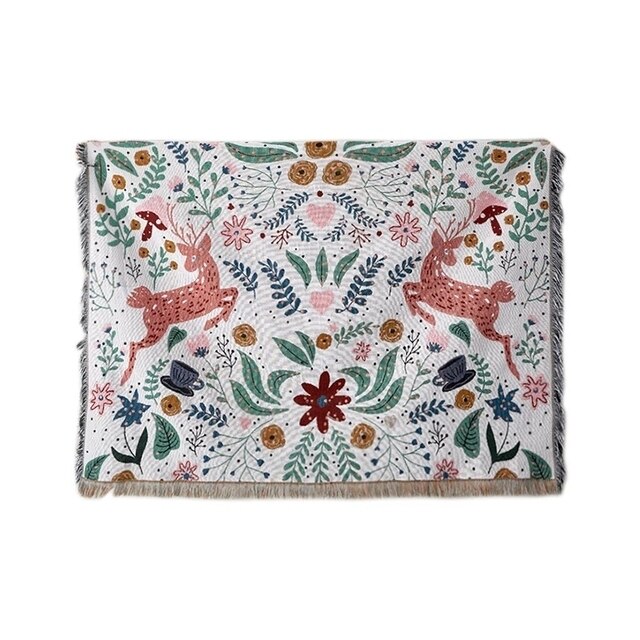 Whimsical nordic garden blanket featuring deer and flowers with fringed edge