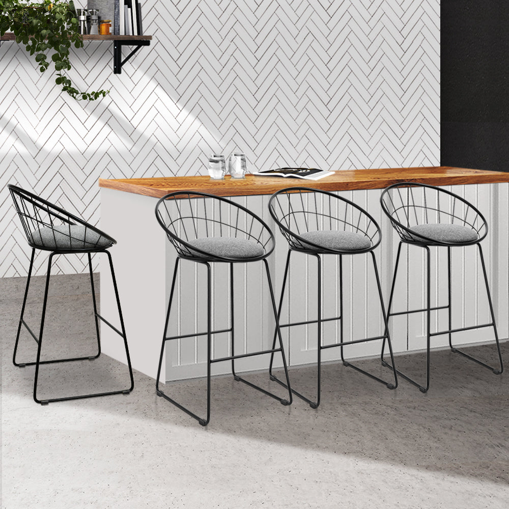 Steel bar stools with grey cushioned seating at kitchen bench