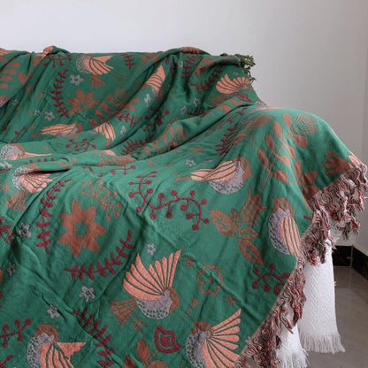 Green cotton blanket with birds flowers close up