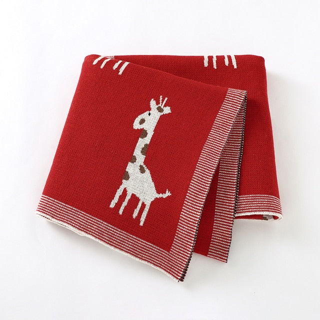 Red cotton knit blanket with giraffes