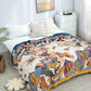 Colourful cotton garden oasis throw blanket with tropical flowers and butterflies on bed