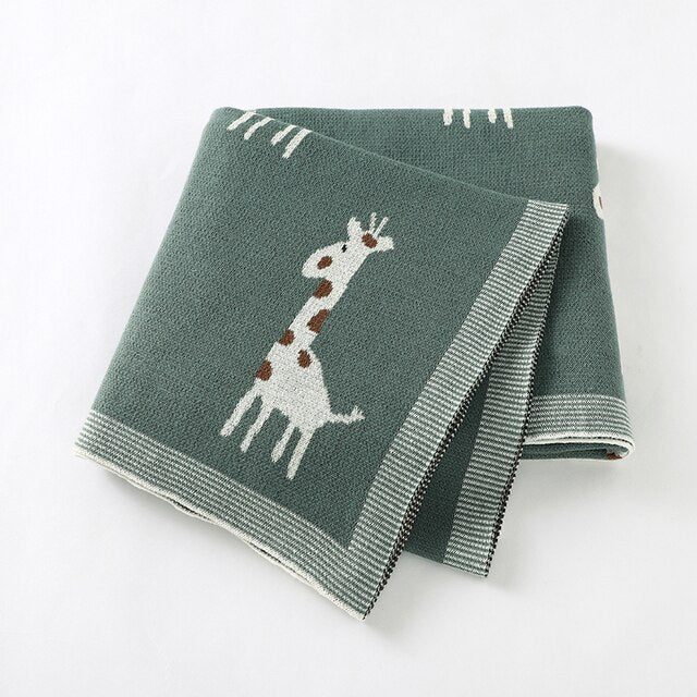 Green cotton knit blanket with giraffes