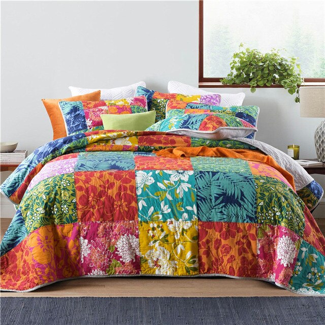 Colourful patchwork quilt and pillow cases on bed 