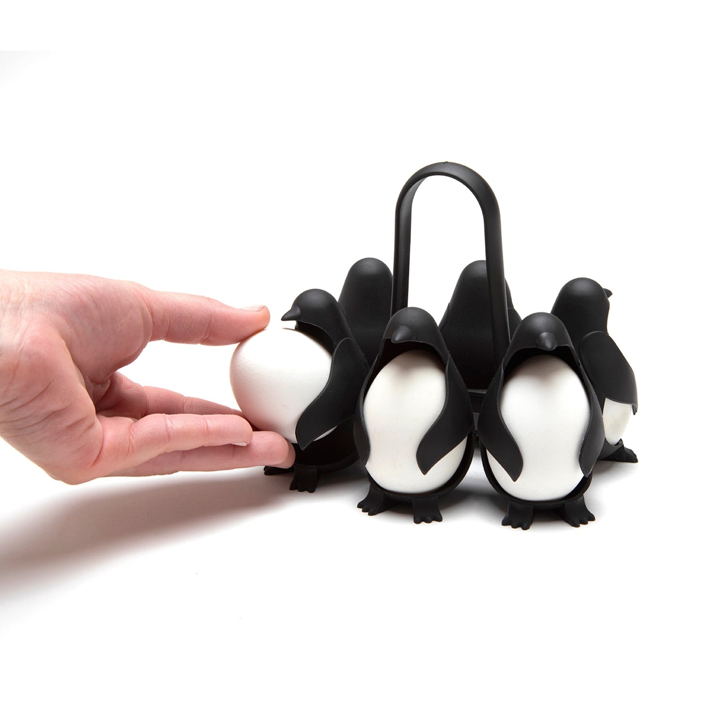 Person placing egg into penguin egg holder