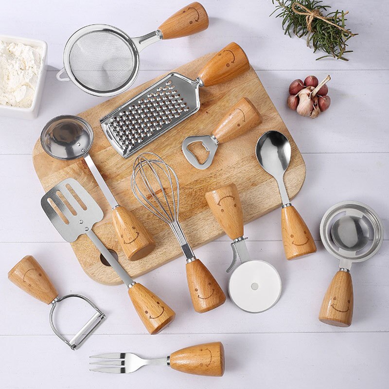 Stainless steel kitchen utensils with wooden handle and smiley face