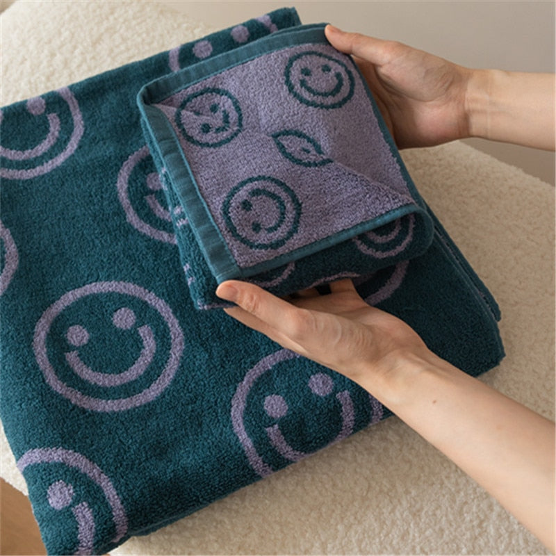 Green purple smiley face towel folded