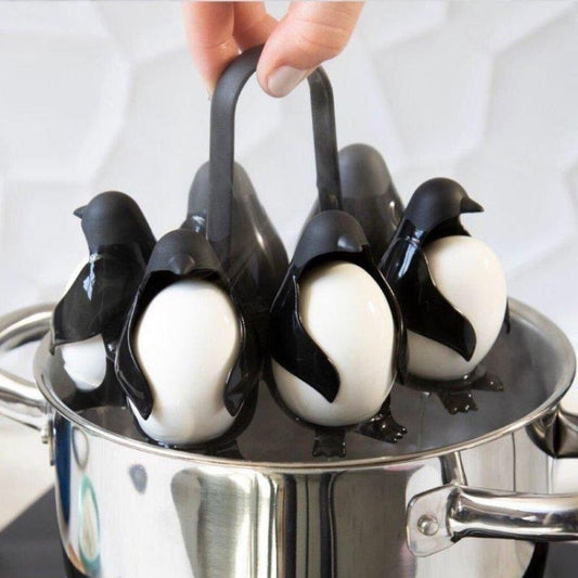 Penguin egg holder with eggs being placed into pot of water