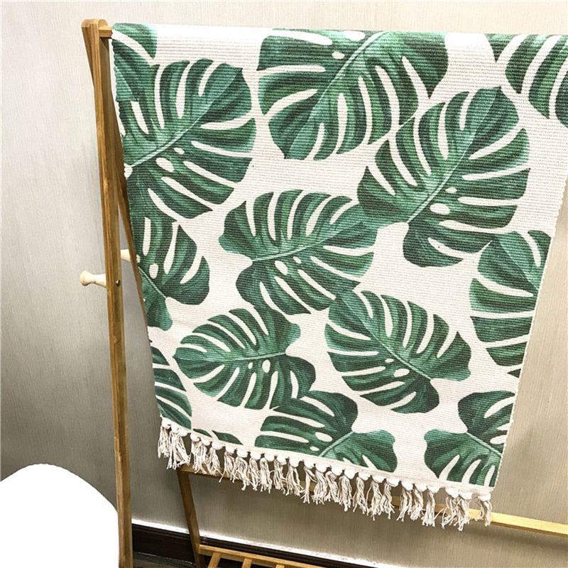 Palm leaf rug hanging up over rail