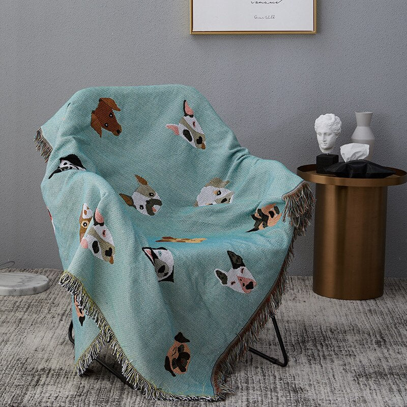 Mint green throw blanket with different dogs on chair