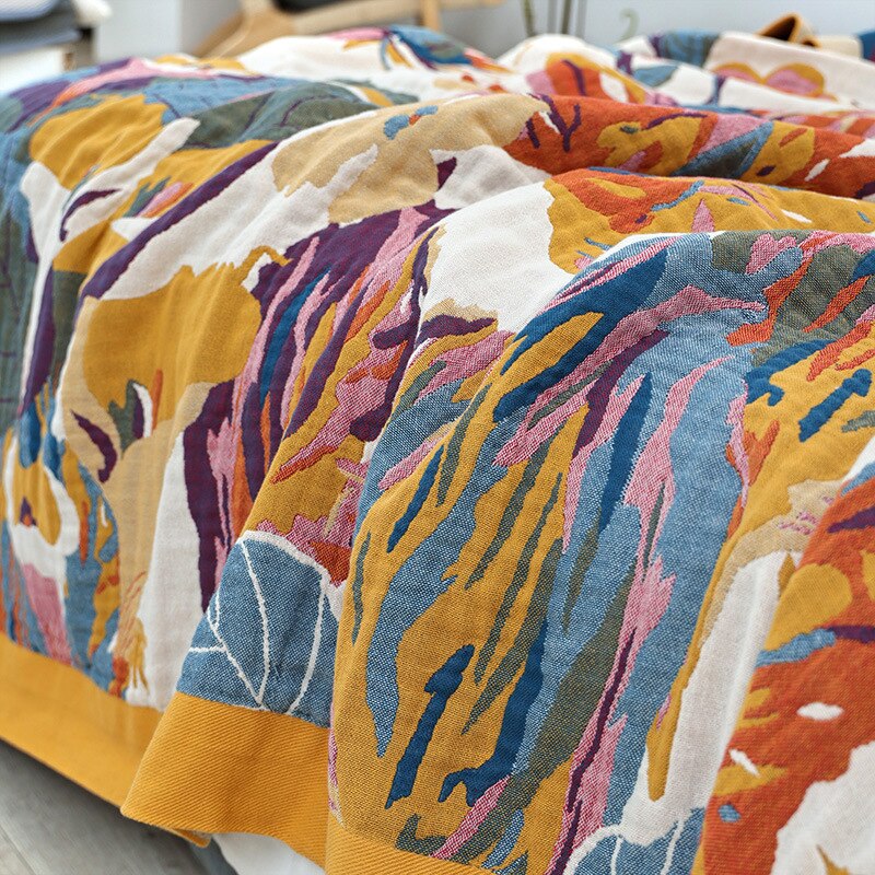 Close up of colourful cotton garden oasis throw blanket with tropical garden flowers