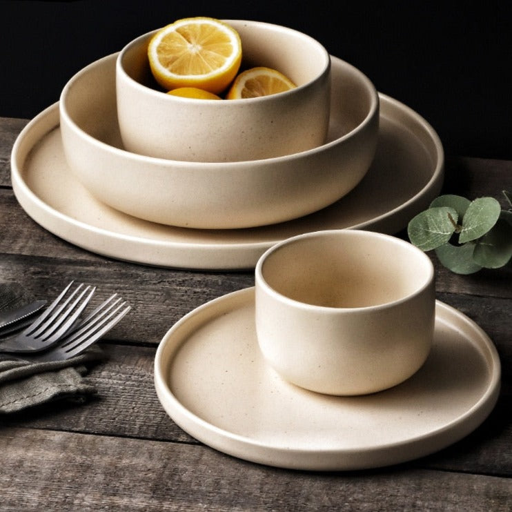 Cream bowls and plates on table