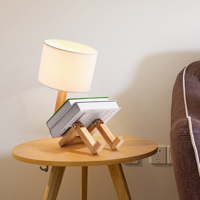 Robot lamp sitting holding books