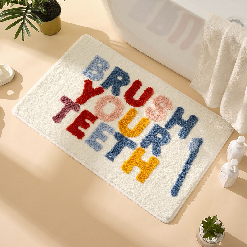 Cream bath mat with message of brush your teeth