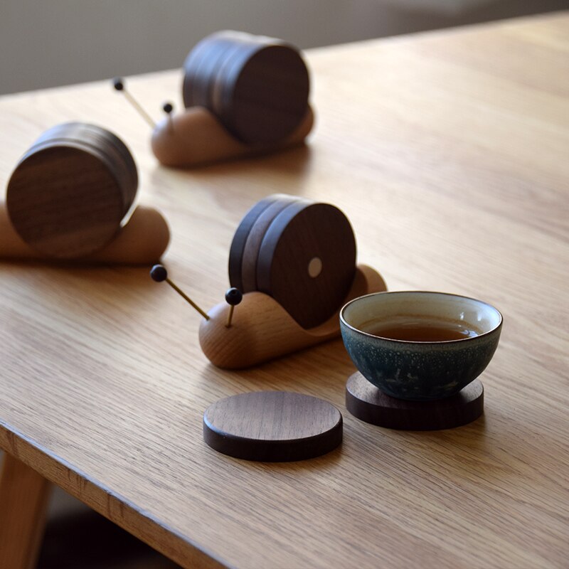 Snail coaster sets with coasters in use and a cup of tea