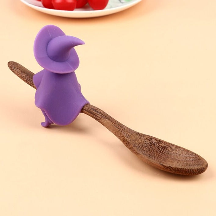 Purple witch from back on wooden spoon with fruit