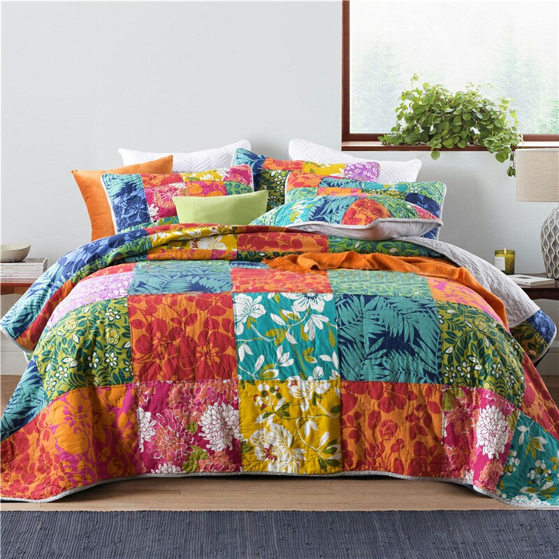 Colourful patchwork quilt and pillow cases on bed 