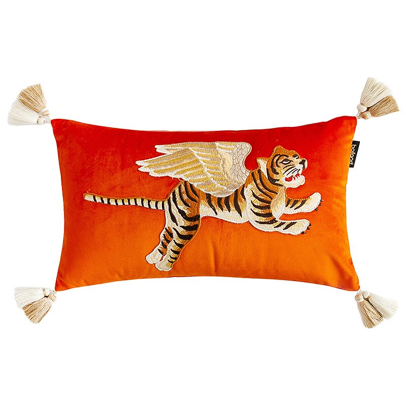 Orange velvet cushion with embroidered flying tiger and tassels on corners