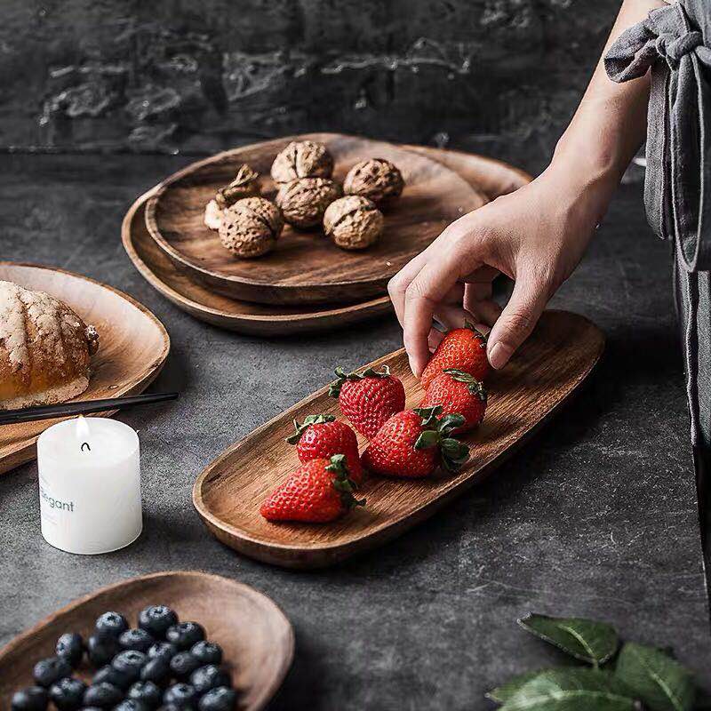 Wooden timber platters various sizes and shapes with strawberries nuts bread