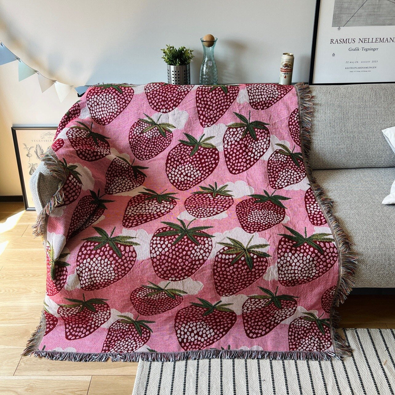 Strawberry blanket with fringe on couch