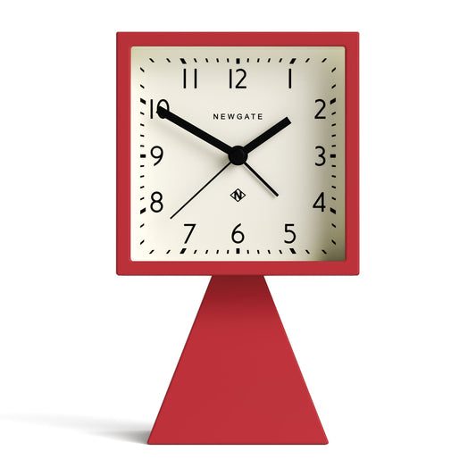 Red alarm clock with square face on pyramid base