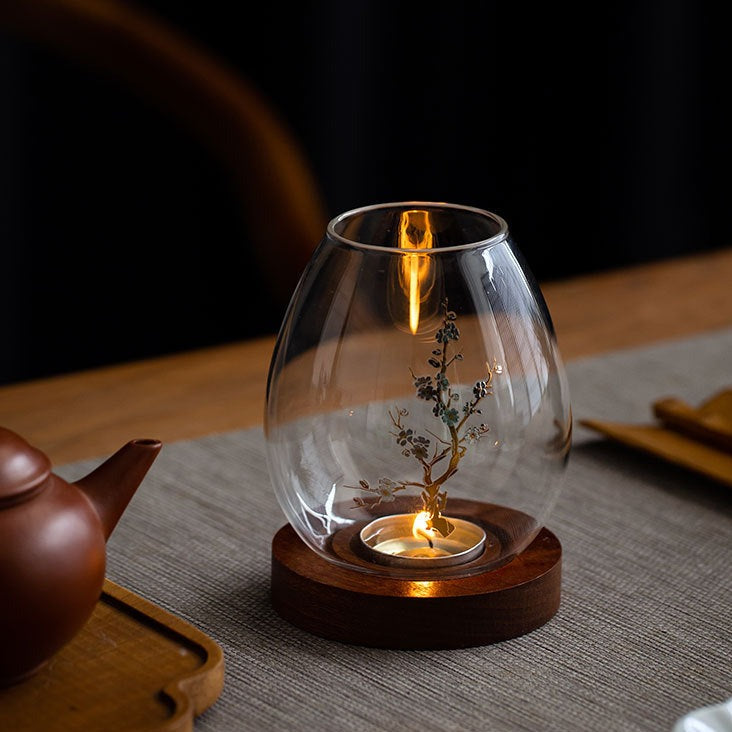 Glass candle holder with blossom branch and timber base