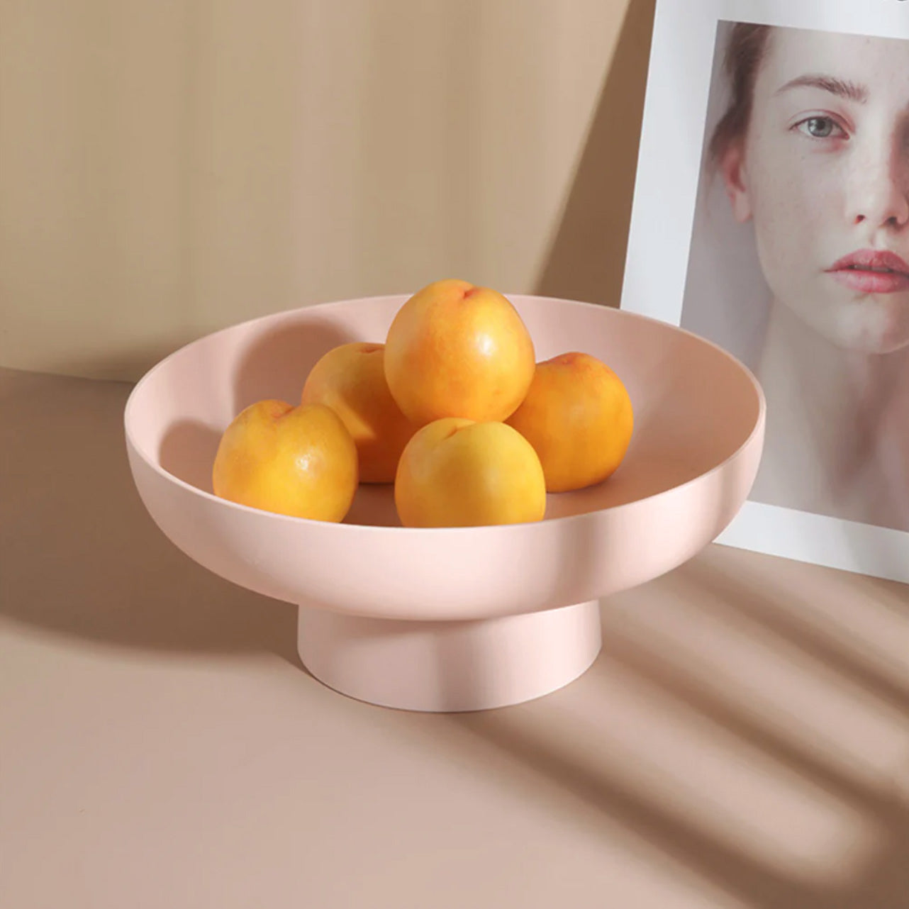 Pink rounded elevated bowl with apricots