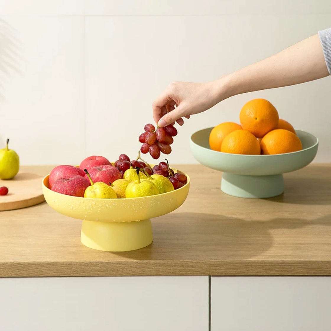 Pastel yellow and mint green rounded elevated bowls with fruit