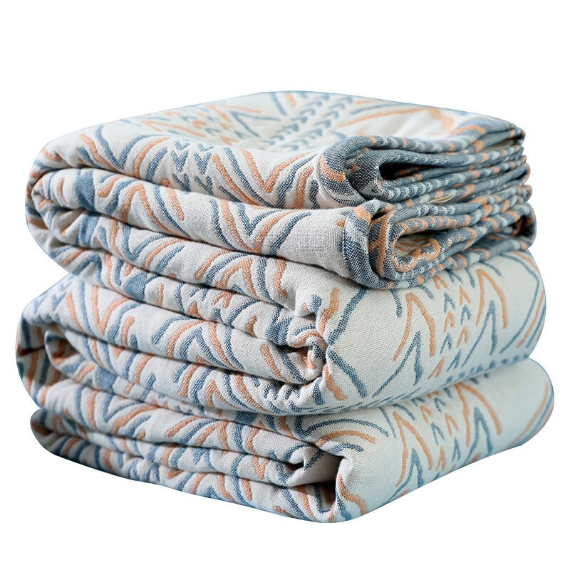 Folded cream cotton throw rugs with blue and orange earth colours