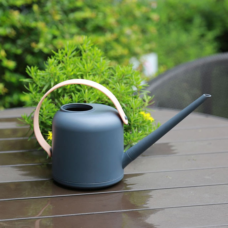 Grey watering can with pink handle