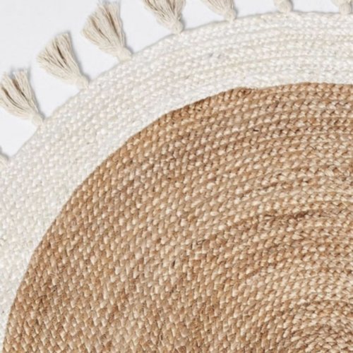 Close up of round rug with tassels handmade from jute and recycled cotton