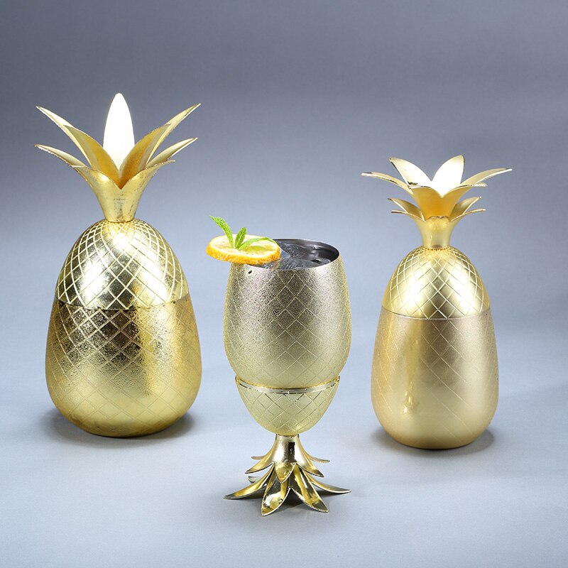 Small and large gold coloured metallic pineapple cocktail mug shown with top on and as stem stand