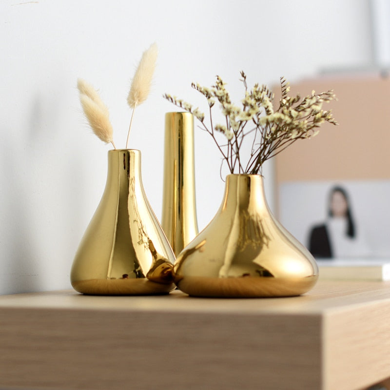 Gold vases in three shapes and sizes