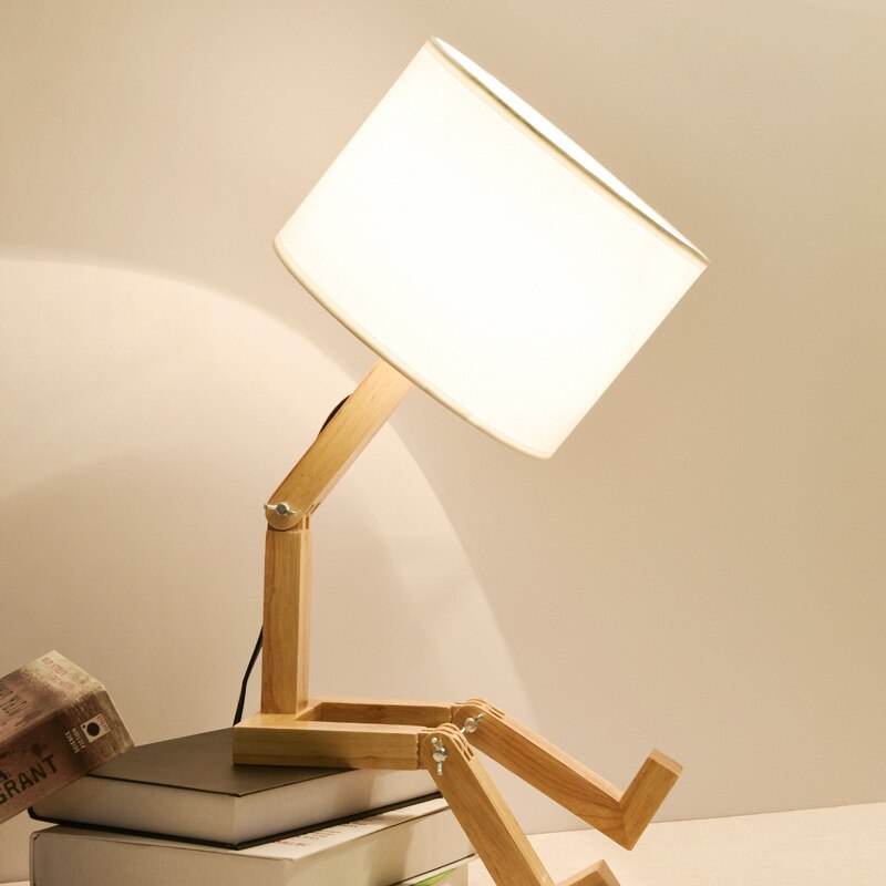 Timber robot lamp white shade sitting on books