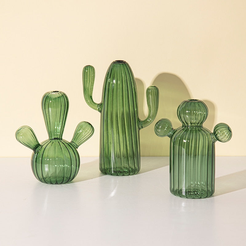 Three green glass cactus vases