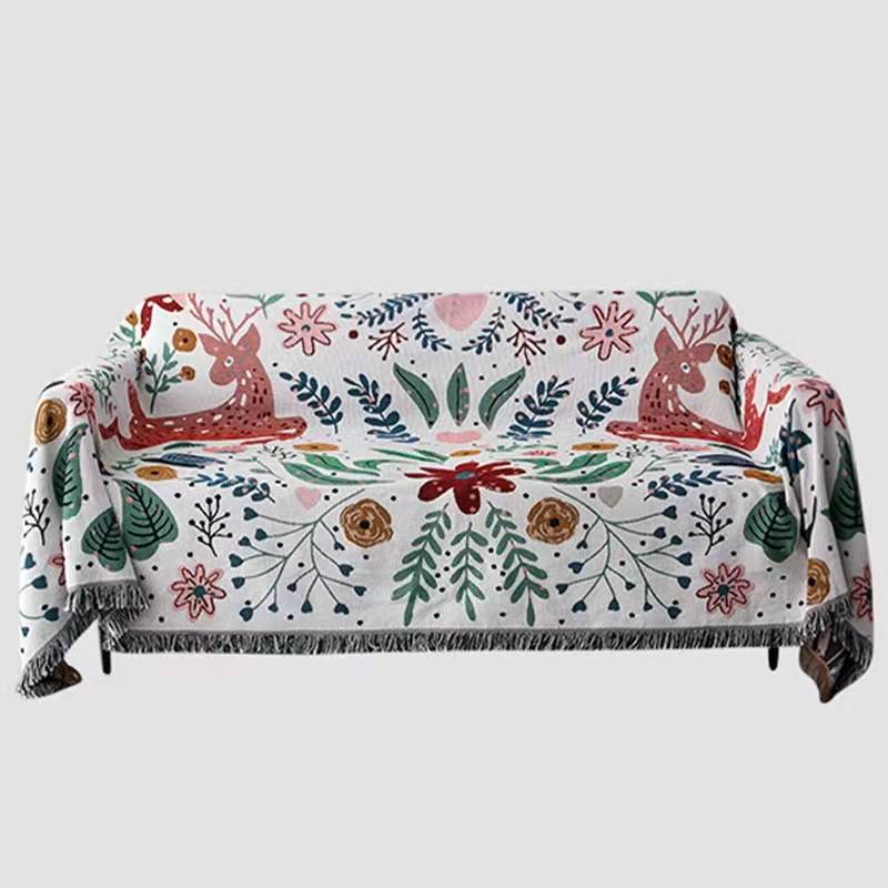 Whimsical nordic garden blanket featuring deer and flowers with fringed edge