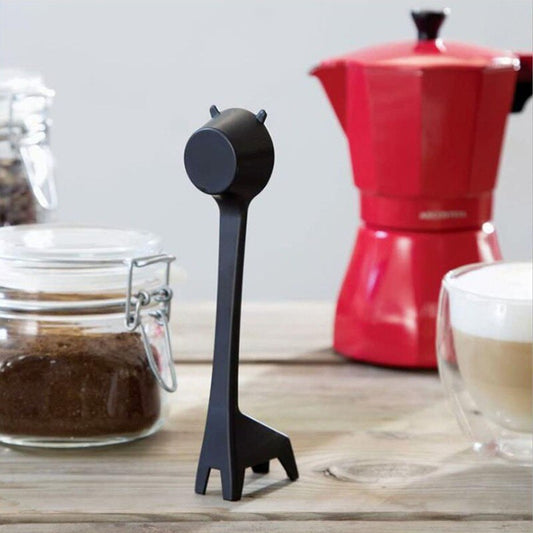 Abstract black giraffe coffee scoop standing on bench with coffee jar pot and cup