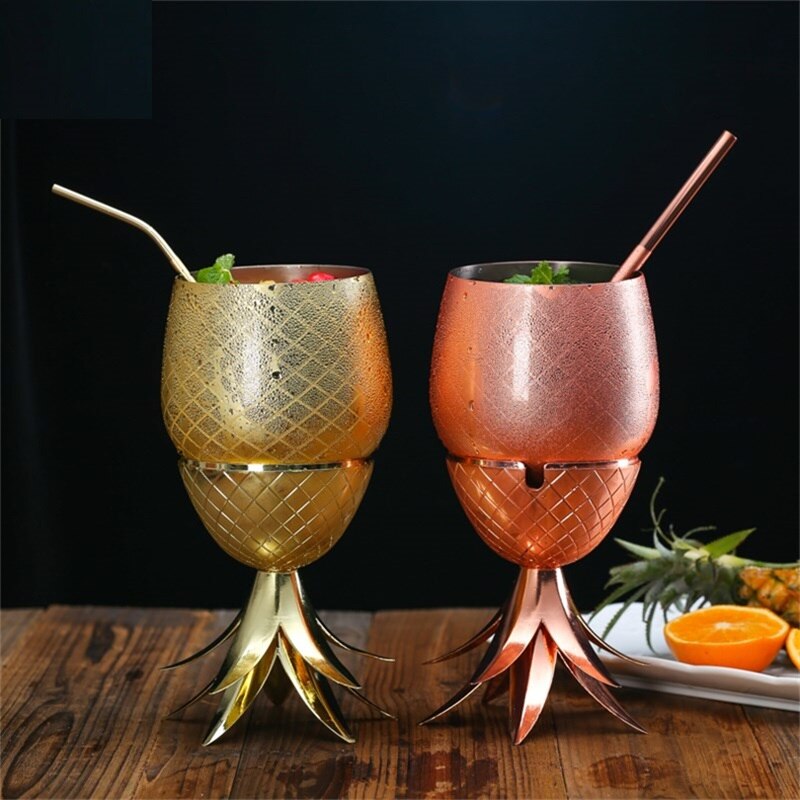 Gold and rose copper metallic pineapple cocktail mug shown as goblet with straws