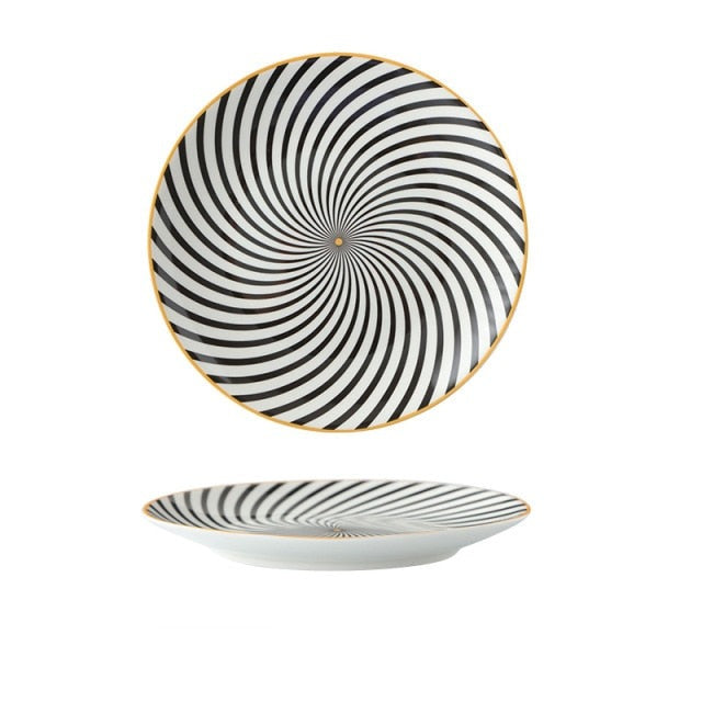 Black and white swirl patterned plate with yellow gold edge and centre