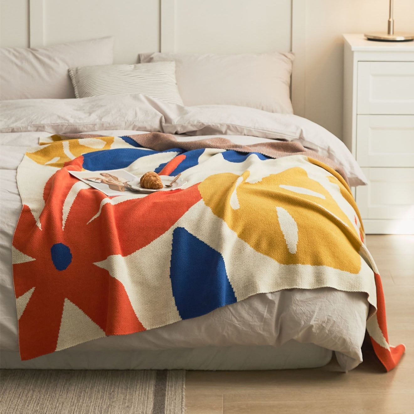 Warm summer leaves cotton knitted blanket on bed