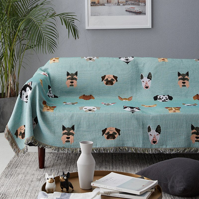 Mint green throw blanket with different dogs on couch