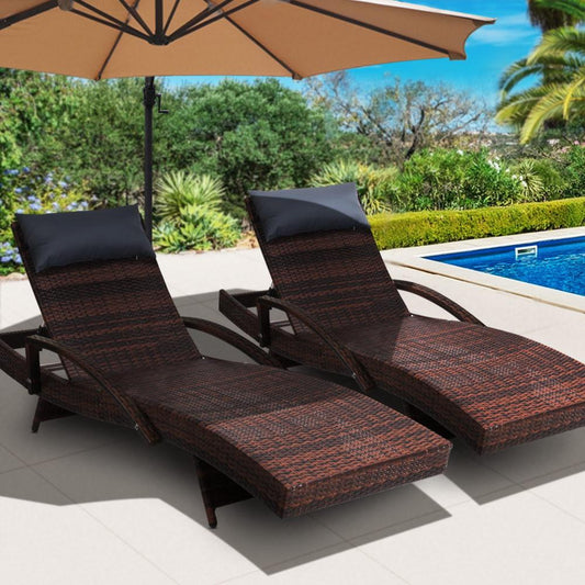 Brown adjustable wicker sun lounges with all-weather pillows