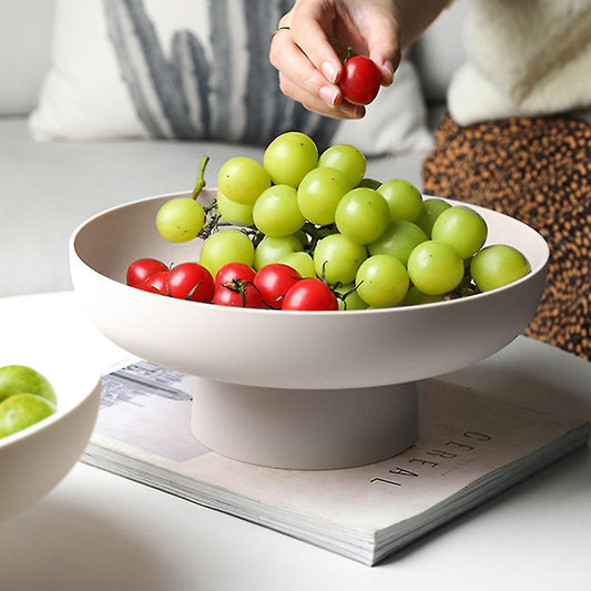 White rounded elevated bowl with fruit